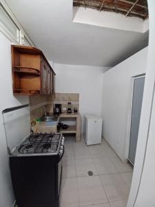 a kitchen with a stove and a sink in it at FAMILY HOUSE CN in Cali