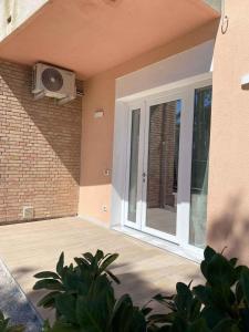 a house with a door and a television on the wall at Apartment in San Michele al Tagliamento 45651 in San Michele al Tagliamento