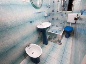 a bathroom with a sink and a toilet at Apartments Ljubo in Stara Novalja