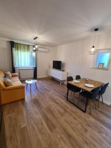 a living room with a couch and a table at Apartment Sani in Supetar +8 photos