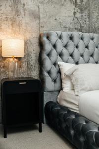 a black couch with a lamp and a side table at Hollywood Designer Apartment in Los Angeles