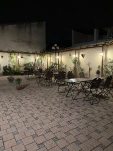 a group of tables and chairs in a courtyard at night at Leimen51 WG3 in Leimen