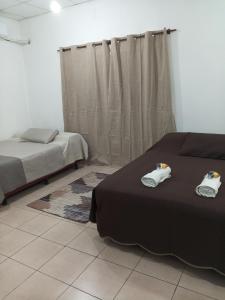 a bedroom with two beds and a window at Alojamiento Temporario Sol de las Yungas in Libertador General San Martín