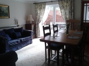 a living room with a table and a couch at Angate Cottage in Wolsingham