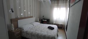 a bedroom with a bed with a black suitcase on it at Modesto piso turístico in Briviesca +5 photos