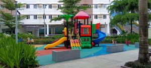 a playground in front of a building at Hope Residences by YsaRiCh Haven in Trece Martires