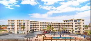 a large apartment building with a playground in front of it at Superior beach studio with Pool Access and free parking in Daytona Beach