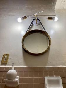 a bathroom with a mirror and a sink at Comodidad de vivir en el centro in Guanajuato