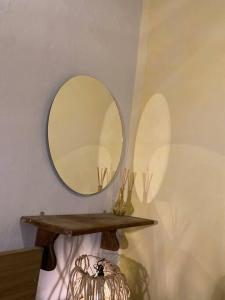 a mirror on a wall with a wooden shelf at Comodidad de vivir en el centro in Guanajuato +8 photos