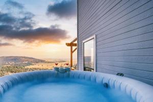 a hot tub on the side of a house at Breathtaking view of the Hills with HotTub, Pool and Pool Table in Marble Mountain