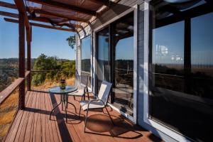 a balcony with a table and chairs on a house at Breathtaking view of the Hills with HotTub, Pool and Pool Table in Marble Mountain
