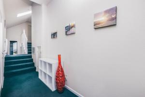 a hallway with a red vase on the wall at Breathtaking view of the Hills with HotTub, Pool and Pool Table in Marble Mountain