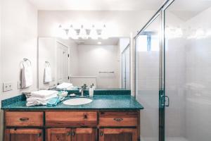 a bathroom with a sink and a shower at Breathtaking view of the Hills with HotTub, Pool and Pool Table in Marble Mountain