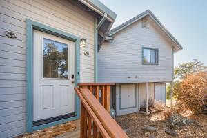a house with a white door and a porch at Breathtaking view of the Hills with HotTub, Pool and Pool Table in Marble Mountain
