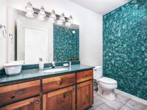 a bathroom with a sink and a toilet at Breathtaking view of the Hills with HotTub, Pool and Pool Table in Marble Mountain