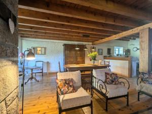 a living room with a dining room table and chairs at Gîte Nature au Chambon-sur-Lignon: Terrasse, Wifi, Proche Activités et Commerces - FR-1-582-137 in Le Chambon-sur-Lignon +23 photos