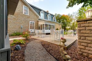 a house with a patio with chairs and a table at Nevis Estate Boutique Hotel in Perth