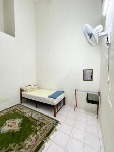 a small room with a bed and a rug at Bed's Homestay Kluang in Kluang