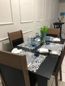 a dining room table with a black table cloth on it at Casa na Praia de Iracema R&S in Fortaleza +10 photos