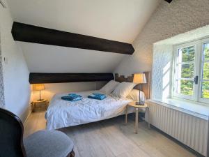 a bedroom with a bed and a window at Gîte Nature au Chambon-sur-Lignon: Terrasse, Wifi, Proche Activités et Commerces - FR-1-582-137 in Le Chambon-sur-Lignon