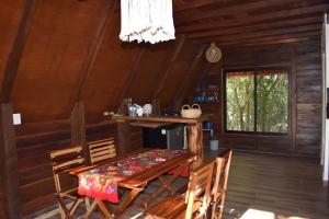 a dining room with a table and chairs in a cabin at Eco Aldea kinich Ahau Calakmul in Xpujil