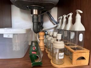 a kitchen counter with a mixer and bottles on a table at Claire's Empire in Lapu Lapu City