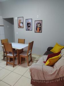 a living room with a table and chairs and a couch at Hotel Glórias - Glórias 1 in Quirinópolis