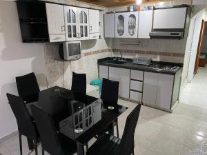 a kitchen with a table and chairs in a room at apartamento Emanuel in Duitama