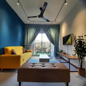 a living room with a yellow couch and a table at V Cozy Homestays in Brinchang