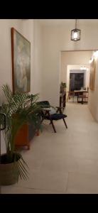 a living room with a couch and a painting on the wall at Casa María Dolores, Barrio San Sebastián in Mérida