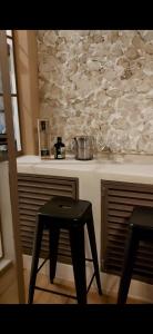 a kitchen with a counter with a table and a stool at Casa María Dolores, Barrio San Sebastián in Mérida