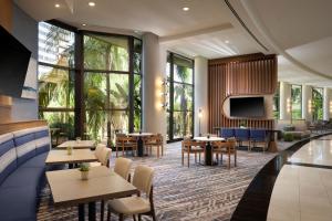 a restaurant with tables and chairs and a tv at Marriott Marquis San Diego Marina in San Diego