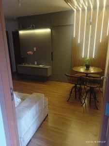a living room with a couch and a table at Quarto Privativo em Apto compartilhado in Uberaba