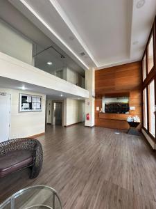 a large empty room with a couch and wooden floors at Departamentos Real in Santiago
