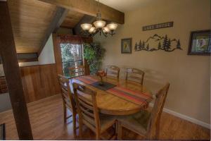 a dining room with a wooden table and chairs at Bear Lake Hideaway condo in South Lake Tahoe