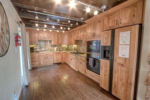 a large kitchen with wooden cabinets and appliances at Snowshoe Chalet cabin in South Lake Tahoe