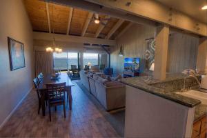 a kitchen and living room with a bar and a couch at Sky Lake Splendor condo in South Lake Tahoe