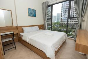 a bedroom with a bed and a large window at Căn hộ cao cấp Lumiere - Vinhomes Grand Park quận 9 2PN, 2WC, miễn phí hồ bơi và gym nội khu in Gò Công +12 photos