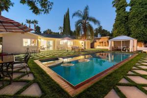 a swimming pool in the yard of a house at Luxury 4BD and 3BA in Topanga Oasis with Pool, Spa and Cabana in Glenview