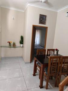 a dining room with a black table and chairs at inactive Krishnarpanam 2BHK villa in Guruvayoor in Guruvāyūr