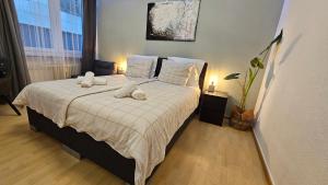 a bedroom with a bed with white sheets and pillows at Top Central Stay - Cozy Bedroom & Kitchen in the Heart of the City and Hauptbahnhof in Wuppertal