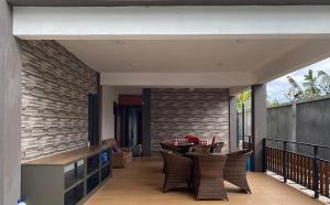 an outdoor patio with a table and chairs at Royal Residency in Plaine Magnien