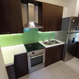 a small kitchen with a sink and a refrigerator at Drosoula house in Chania Town +8 photos