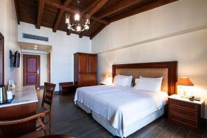 Rúm í herbergi á Itilo Traditional Hotel