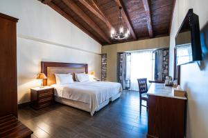 Rúm í herbergi á Itilo Traditional Hotel