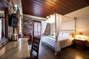Rúm í herbergi á Itilo Traditional Hotel