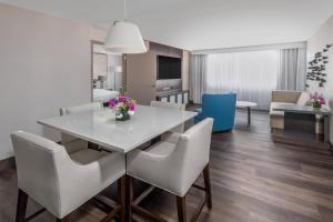 a dining room and living room with a table and chairs at Madison Marriott West in Middleton +48 photos