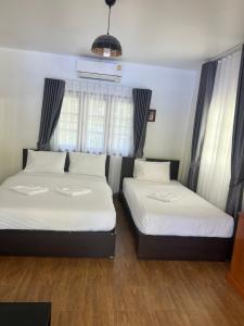 Postel nebo postele na pokoji v ubytování Thipburee Resort