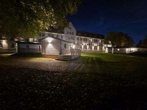 a large building at night with lights on at Stora Ekeberg vandrarhem in Axvall