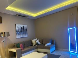 a living room with a couch and a blue light at Pompei Duplex Apartment Deluxe in Boscoreale